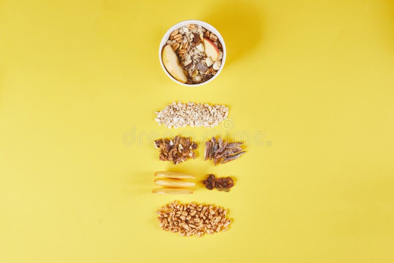Bowl with Tasty Granola and Ingredients on Color Background Stock Photo