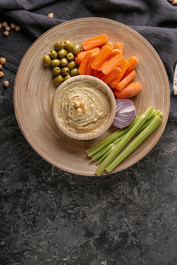 Bowl with Tasty Hummus and Vegetables on Dark Table Stock Photo Image