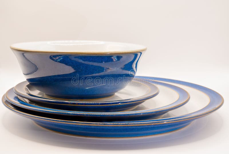 Bowl and Three Crockery Plates of White and Blue Colors Stock Image