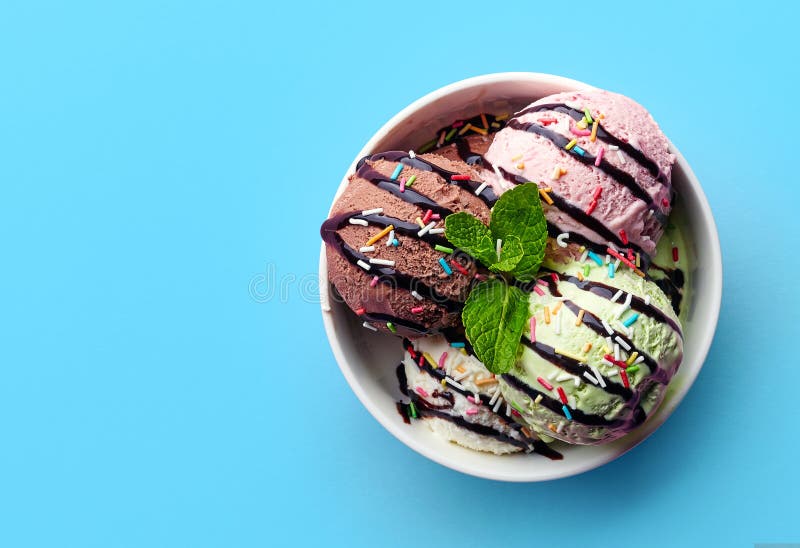 Bowl of various colorful ice cream and chocolate sauce