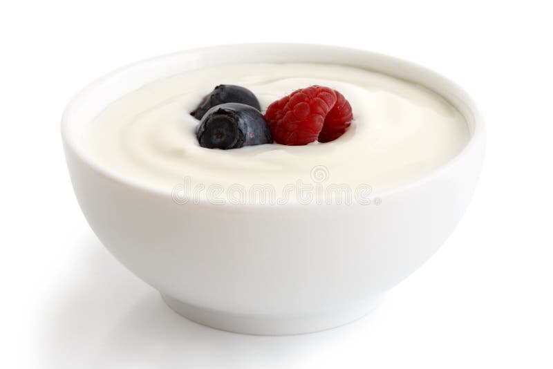Bowl of yoghurt. Ceramic bowl of white yoghurt with berries isolated on white background royalty free stock photo