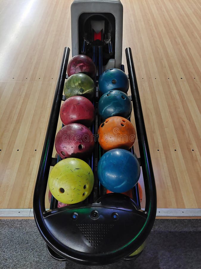 Bowling Balls of Different Colors Lie in Two Rows on a Bowl Stand Stock