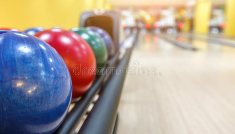 Bowling background. Interior of bowling alley lane with balls return machine closeup, selective focus on blue ball. Closeup machine tool stock images, royalty-free photos and pictures