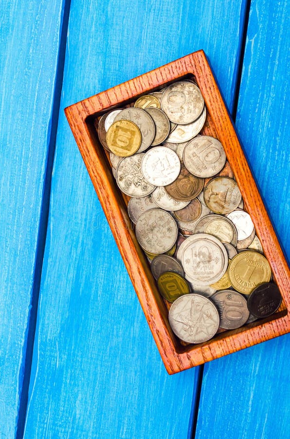 box with coins of countries of the world on a blue wooden background. money.a Palestinian coin, a Soviet coin, an Israeli royalty free stock image box with coins of countries of the world on a blue wooden background. money.a Palestinian coin, a Soviet coin, an Israeli royalty free stock image