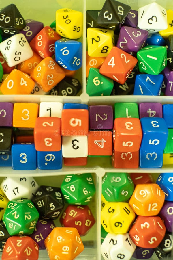 Box full of dice of different colors and shapes for role-playing games royalty free stock photo