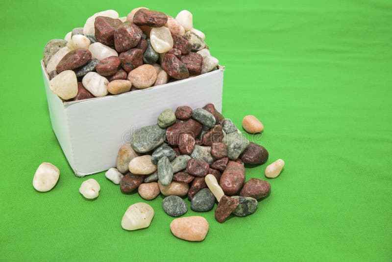 Box of rocks loose green background