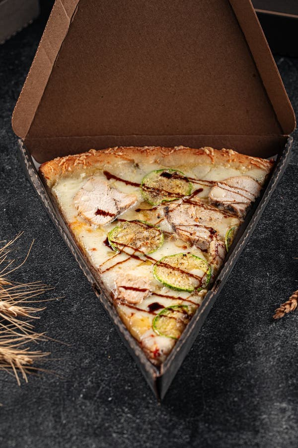Box with Slice of Giant Chicken and Zucchini Pizza Stock Photo Image