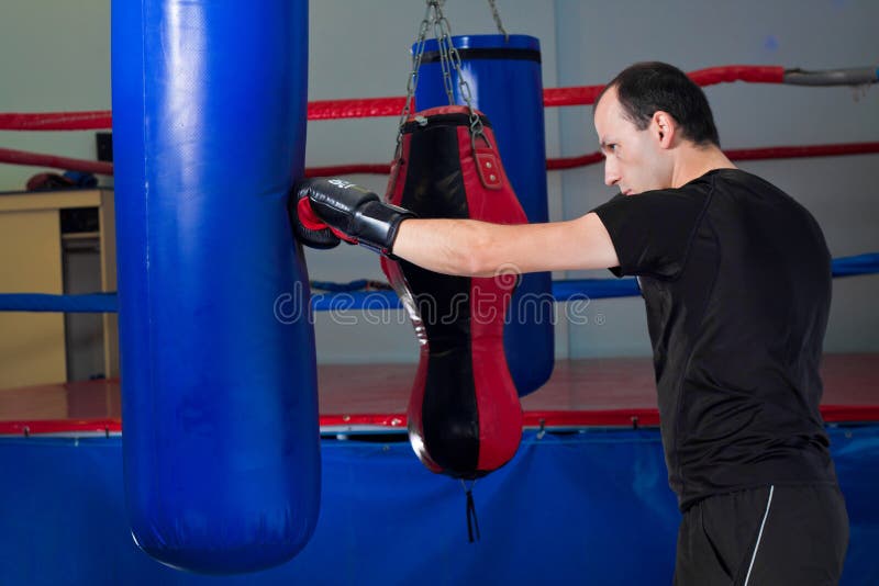 Boxer punching a sand bag with back hand