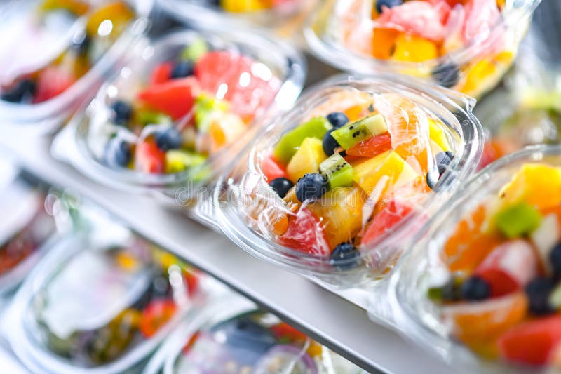 Boxes with Prepackaged Fruit Salads in a Commercial Fridge Stock Photo