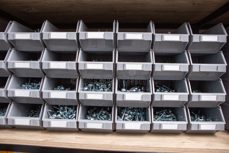 Boxes with Screws in Plastic Boxes that are on a Shelf in the Tool and