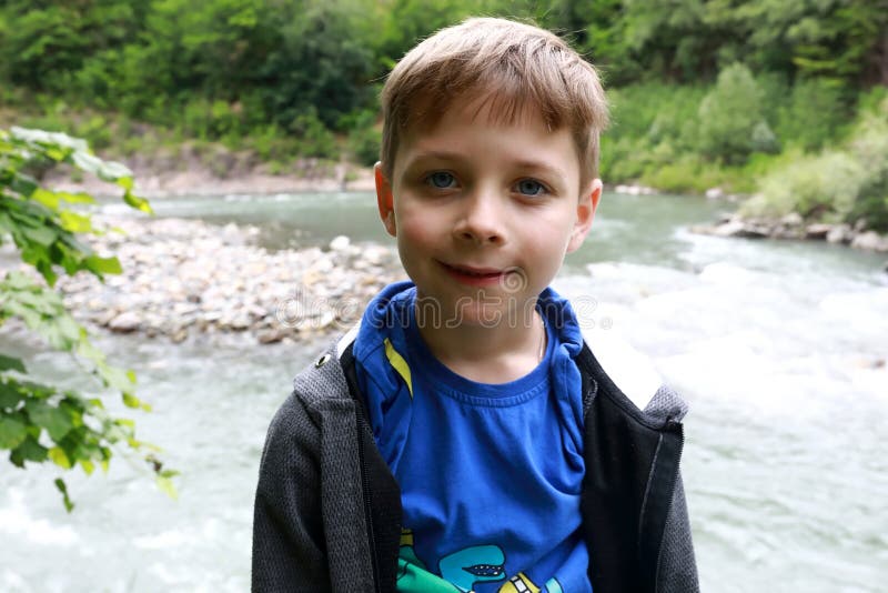 Boy on bank of Belaya river in granite gorge stock photo