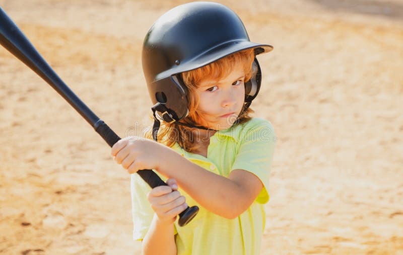 Boy in Baseball Helmet and Baseball Bat Ready To Bat. Stock Photo