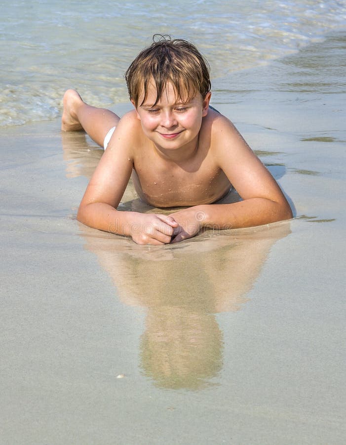 Boy at the beach enjoys the sandy beach