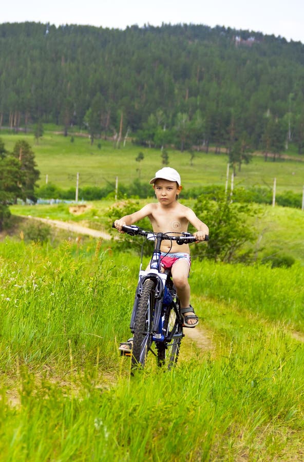 Boy on bike rides stock photo. Image of leisure, lifestyle 25807520