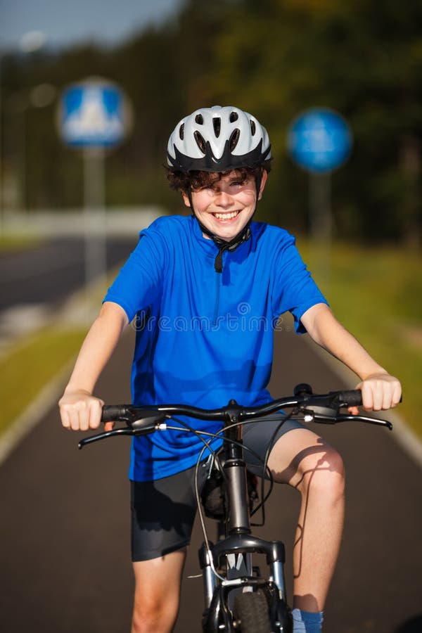 Smiling Boy Riding Bike stock photo. Image of happy, young 30231714