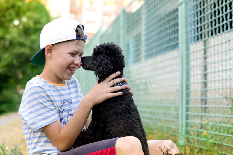 Boy with a black poodle