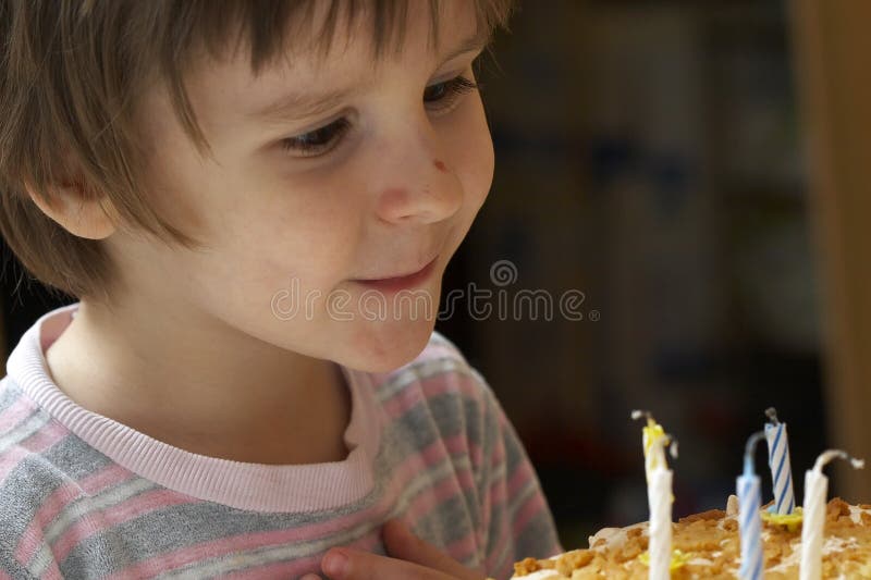 Boy blow out celebratory candles