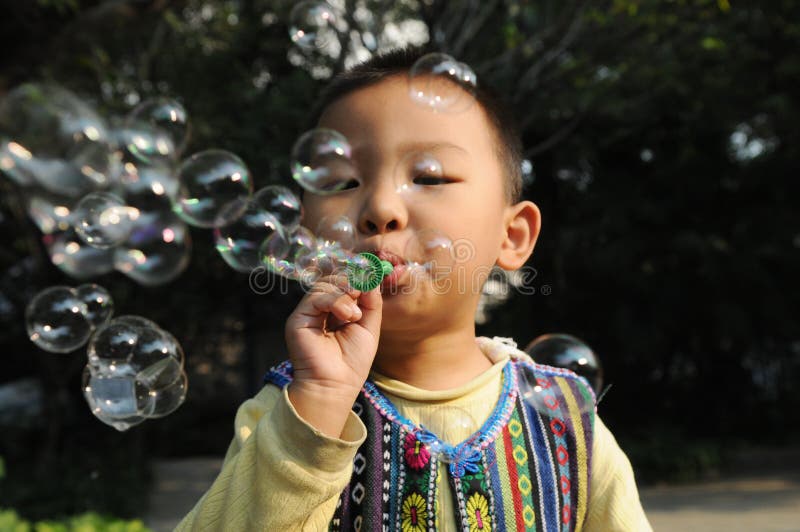 A boy blowing bubbles