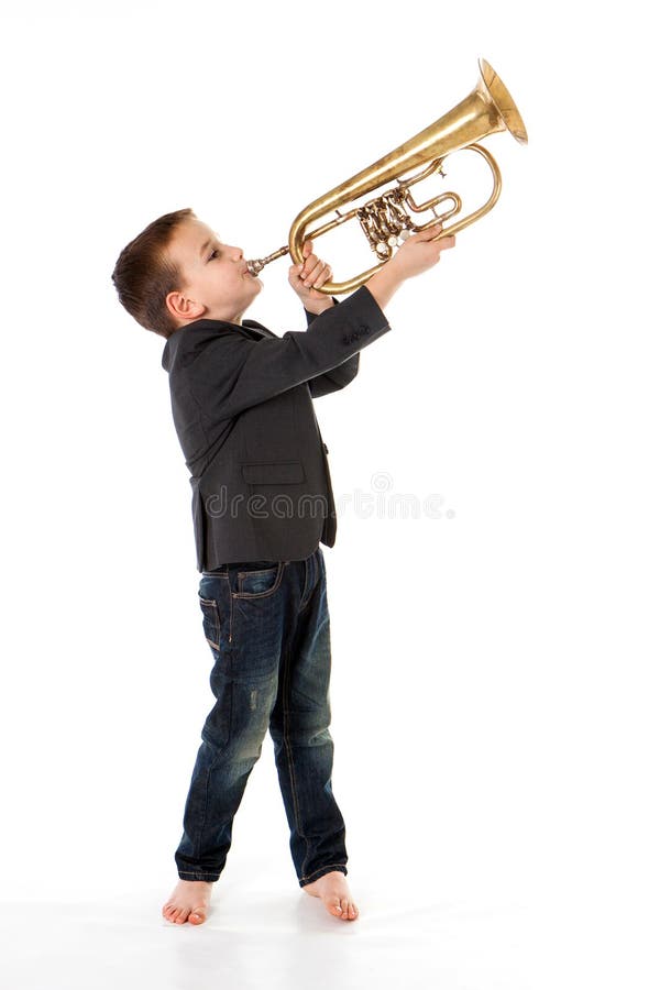 Boy blowing into a trumpet stock image. Image of background 91623677