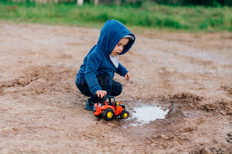 Little Boy Playing with Color Toys on Floor Stock Photo - Image of  bulldozer, little: 19039326