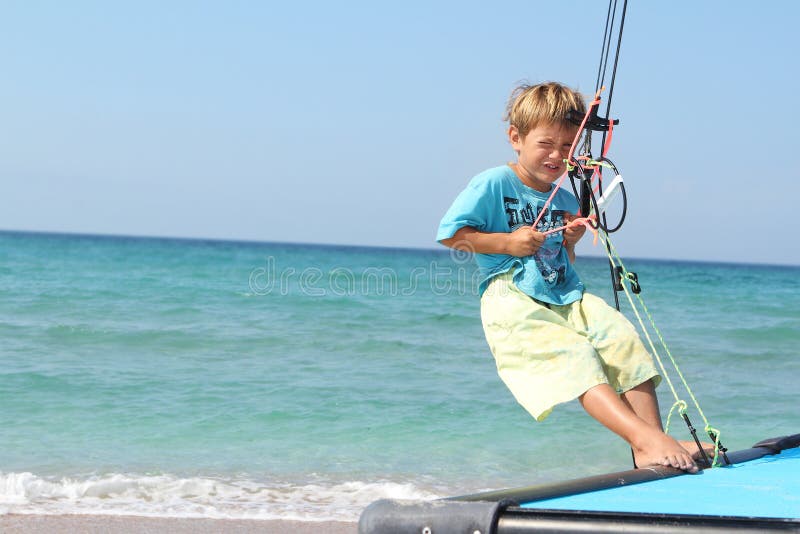 Boy on board of sea catamaran