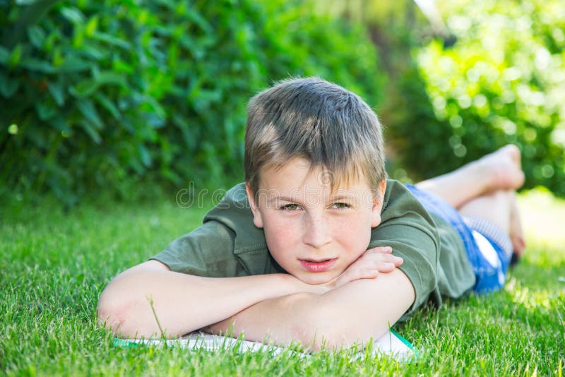 Boy with a Book on the Grass Stock Image - Image of playground ...