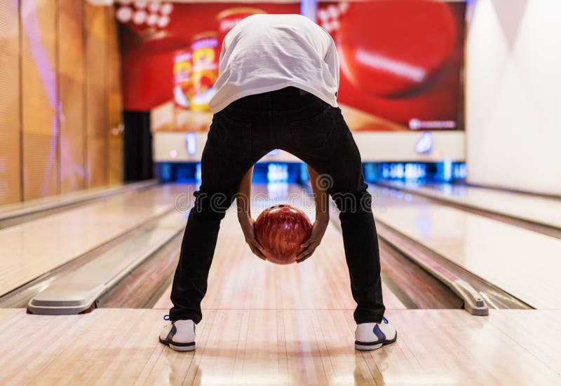 Boy bowling with two hands stock photo. Image of mature 112627868