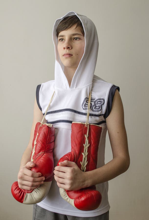 Boy in Boxing Gloves with Raised Hands in Victory Gesture Stock Image