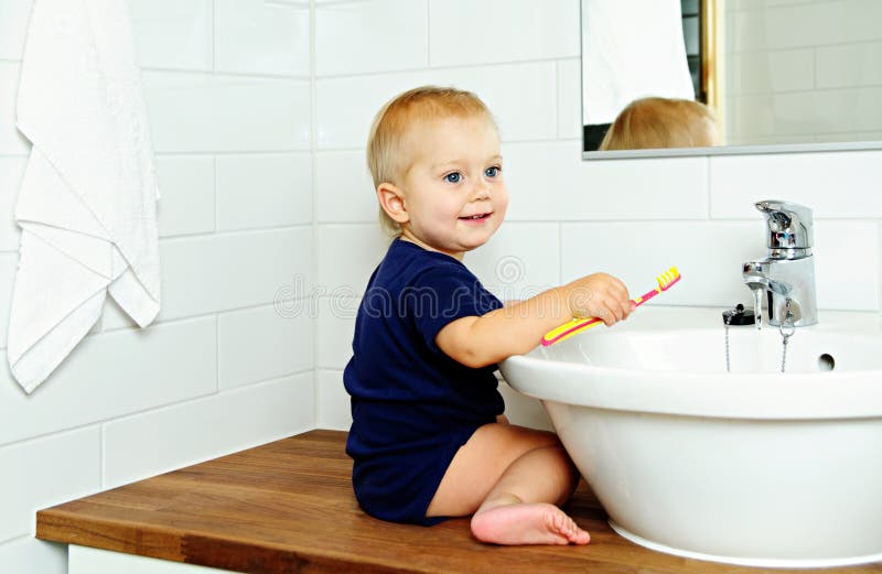 Boy brushes teeth