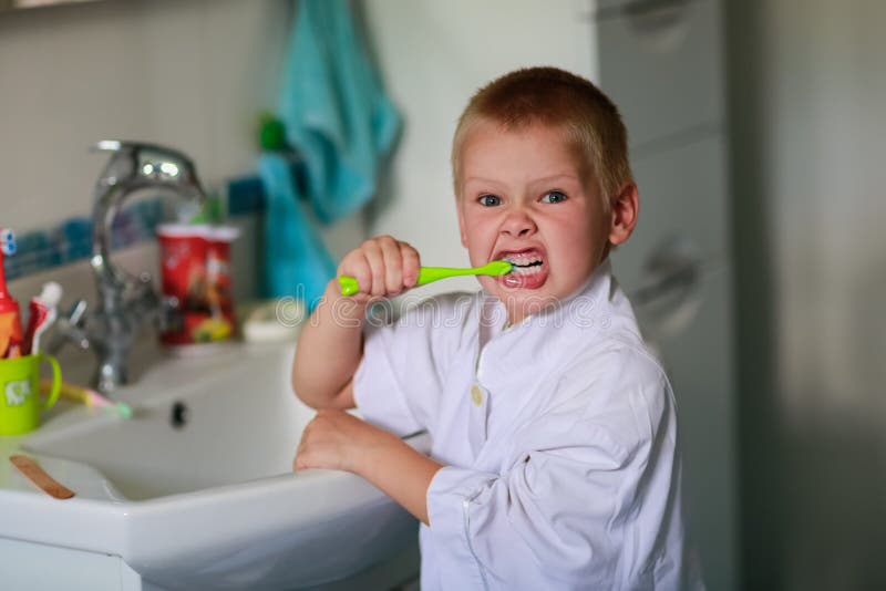 Boy brushing his teeth stock photo. Image of action, human 57985332