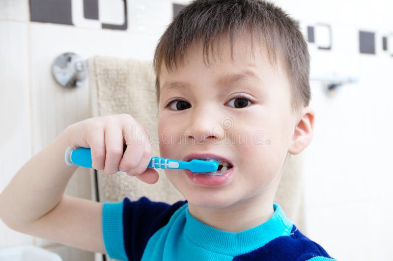 Boy brushing teeth, child dental care, oral hygiene concept, child portrait in bathroom with tooth brush