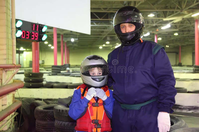 Boy and carting trainer are standing in helmets
