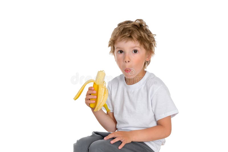 Boy chews a ripe and delicious banana