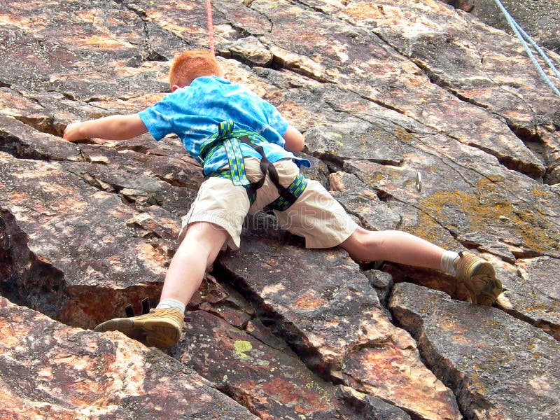 Boy climbing on rope