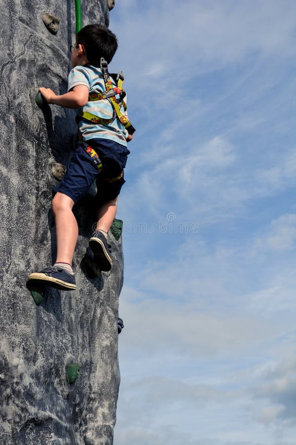 Boy Climbing Wall Outdoors