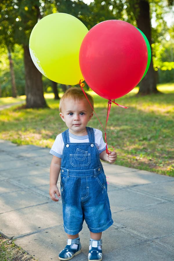 A boy with colorful baloons