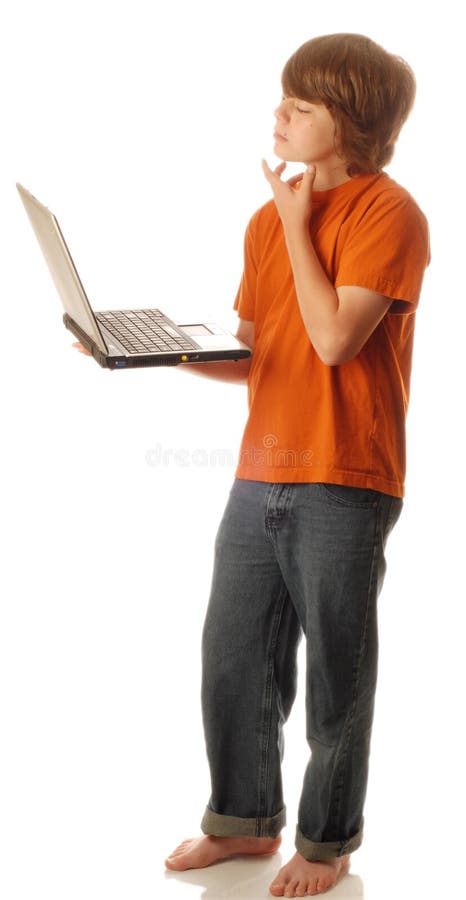 Boy on computer thinking stock photo