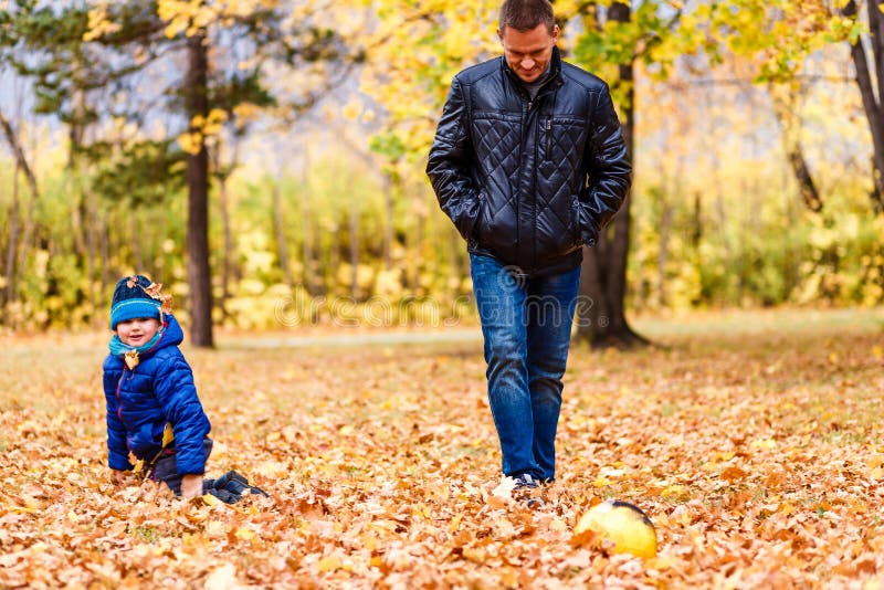 Boy and dad kick ball stock photo. Image of football 163183048