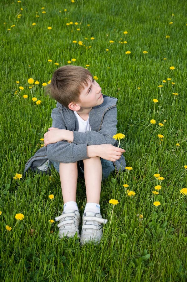 Boy on dandelion meadow