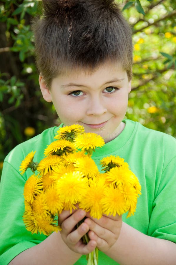 A boy with a dandelions