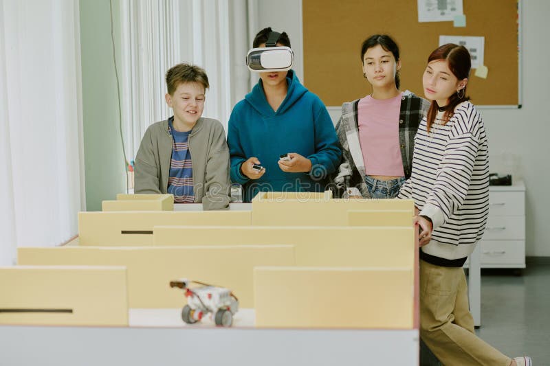 Classmates Watching Boy Playing Video Game stock image