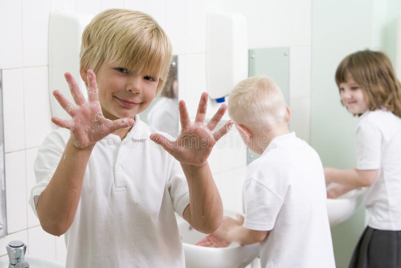 A Boy Displaying His Hands in a School Bathroom Stock Image Image of