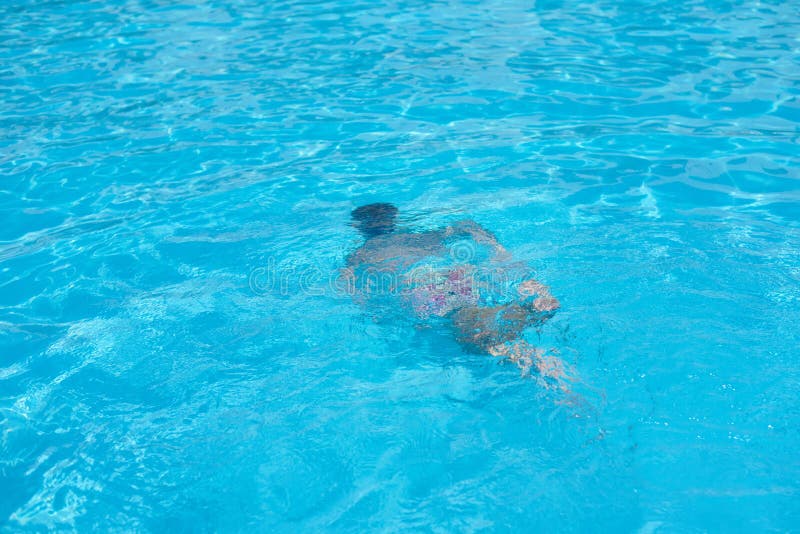 Boy in diving mask swim underwater in the swimming pool stock image Boy in diving mask swim underwater in the swimming pool stock image