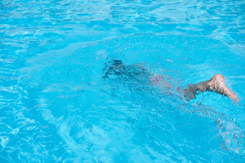 Boy in Diving Mask Swim Underwater in the Swimming Pool Stock Image