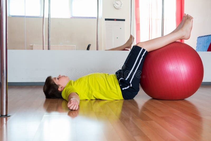 Boy Does Exercise with the Ball in Gym Stock Image Image of playful