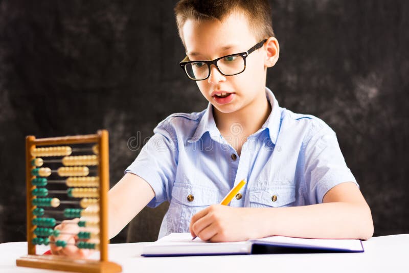 video of little boy doing math homework