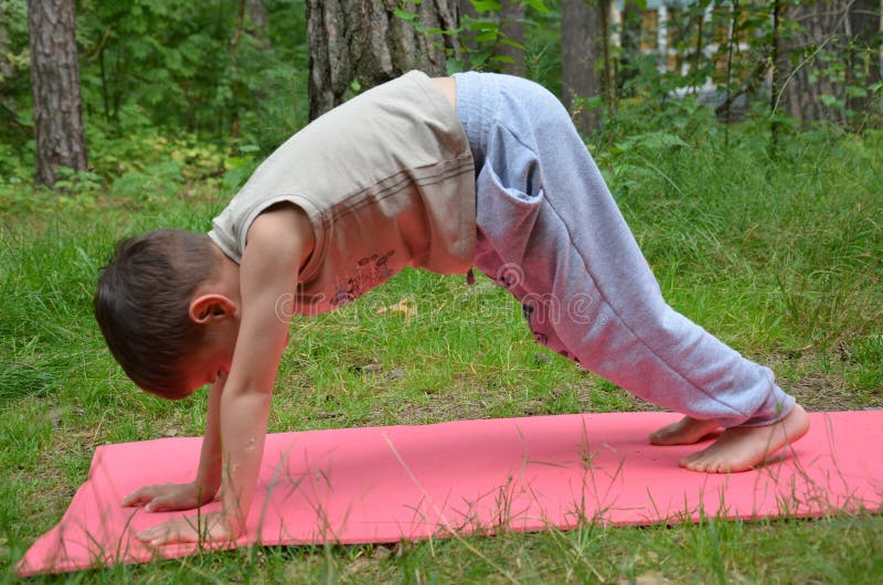 Baby doing yoga exercises. Downward Facing Dog pose. Adho Mukha Svanasana royalty free stock photo Baby doing yoga exercises. Downward Facing Dog pose. Adho Mukha Svanasana royalty free stock photo