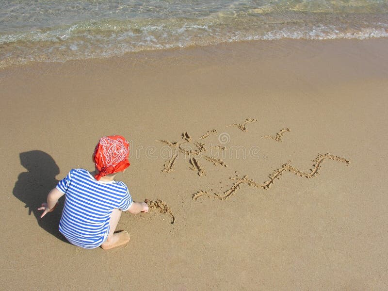 Boy draw on beach