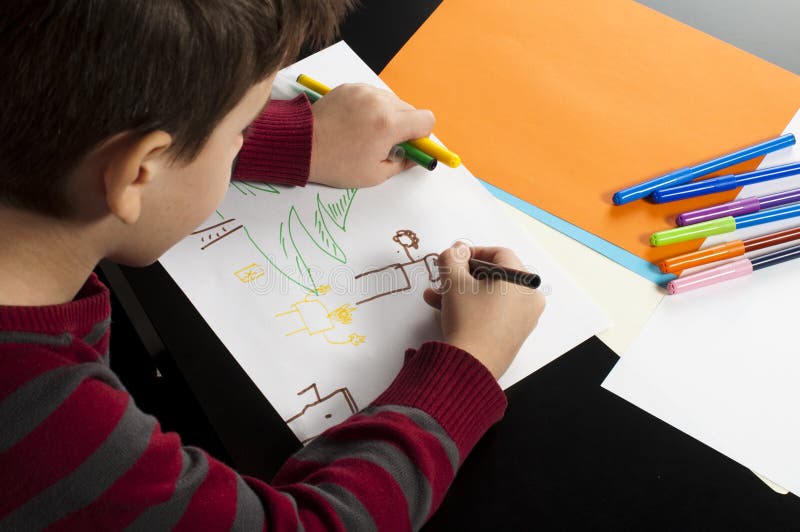 Boy drawing with markers