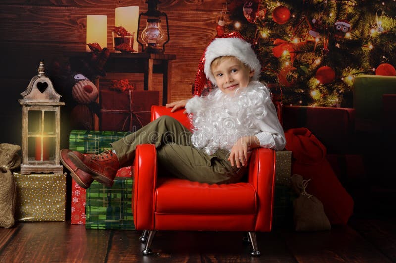 Boy dressed in Santa Claus`s Christmas stock photo Boy dressed in Santa Claus`s Christmas stock photo
